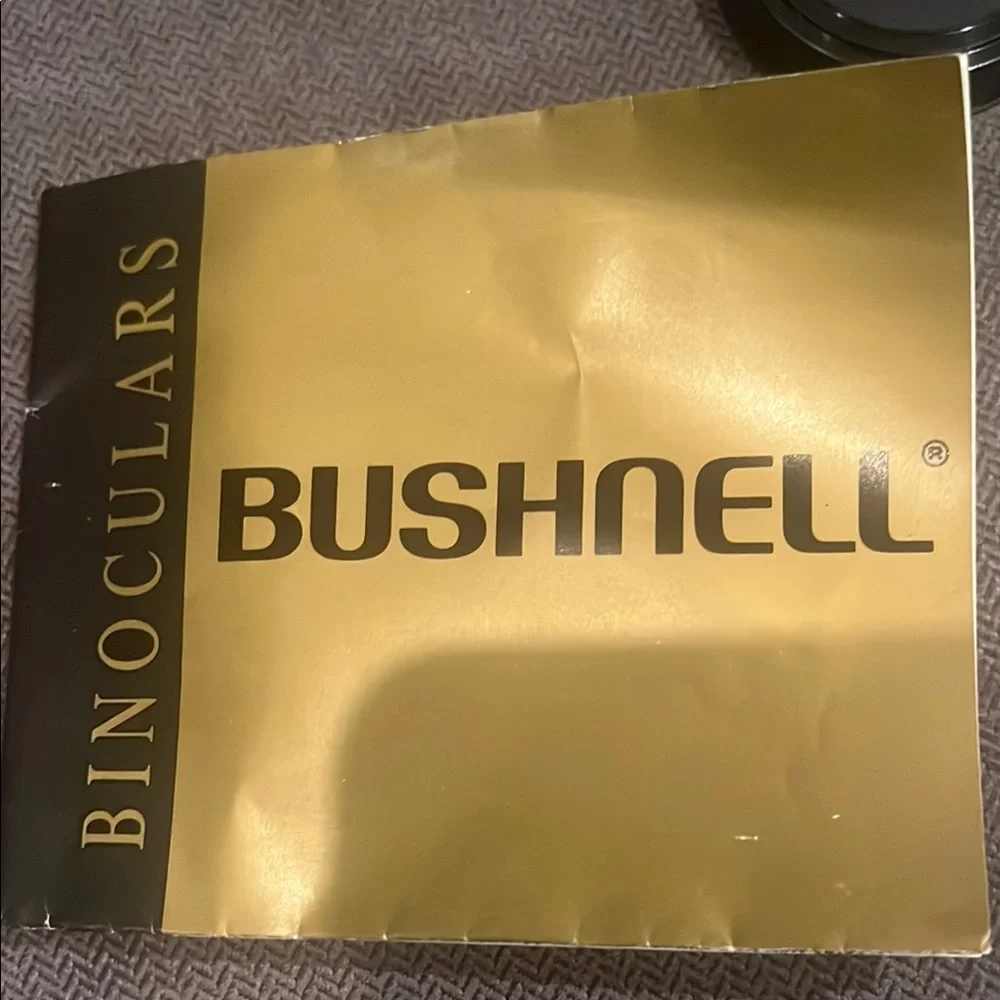 Black Bushnell Binoculars with Rubber Armor and Central Focus